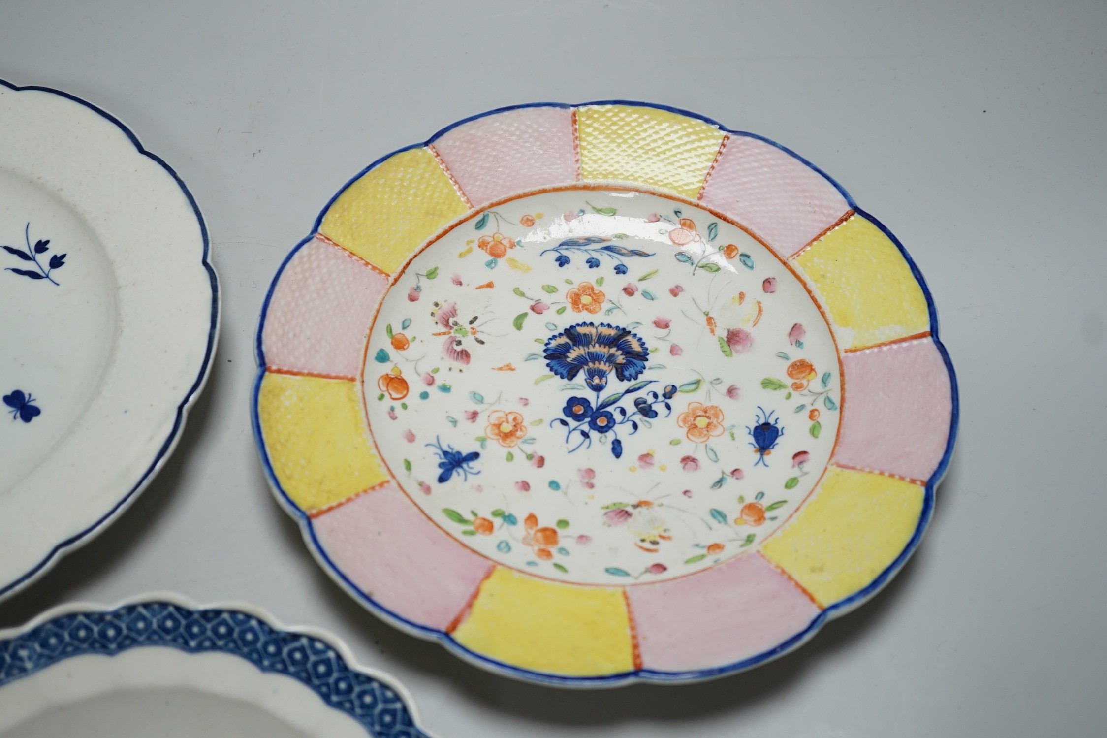 An 18th century Caughley plate printed with Gillyflower variation 5, 20.5cms diameter and two plates with the Carnation pattern, one with added polychrome decoration